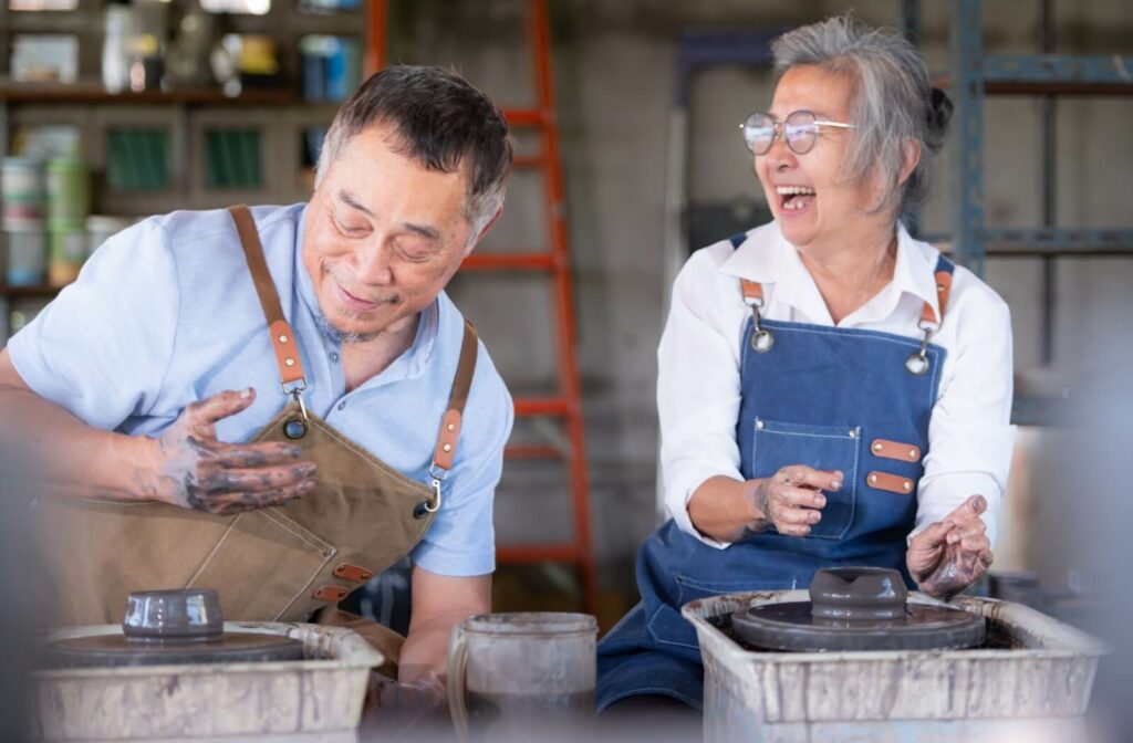 A mature couple attending a pottery activity together.