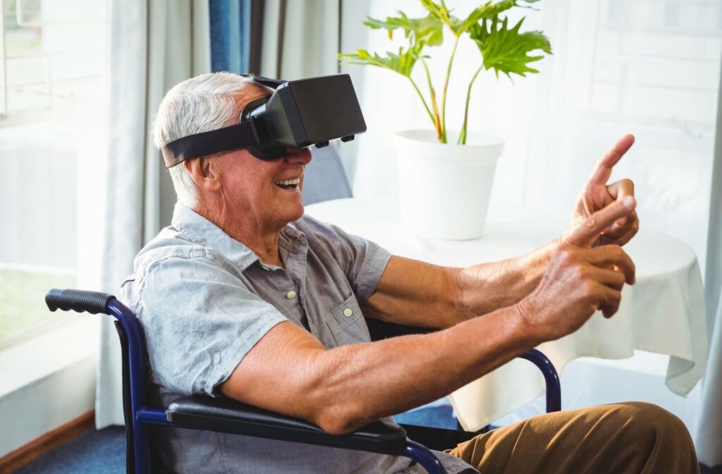 An older adult male in a wheelchair using a virtual reality headset to travel.