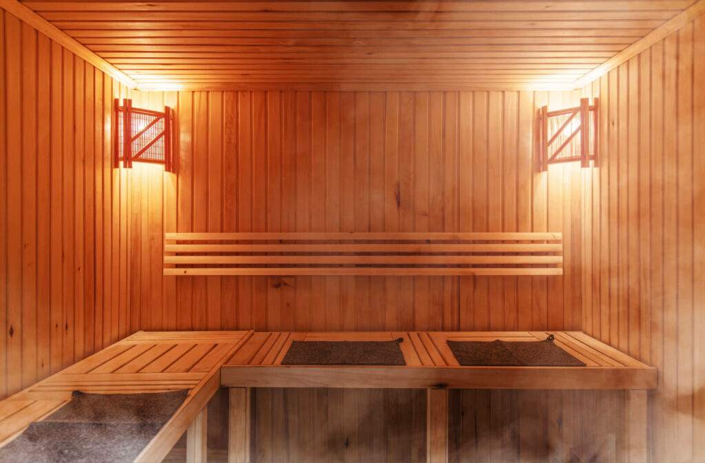 A wood-paneled sauna with steam rising through the room.